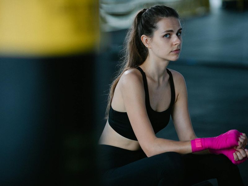 Person hands preparing for activity in a gym.