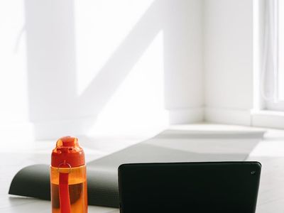 Yoga mat and water bottle in a minimalist room.